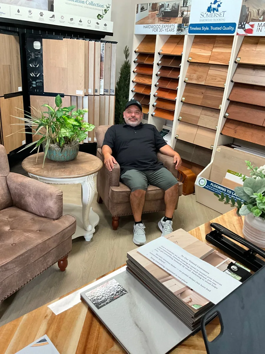 Carlos Garcia relaxing in his flooring showroom