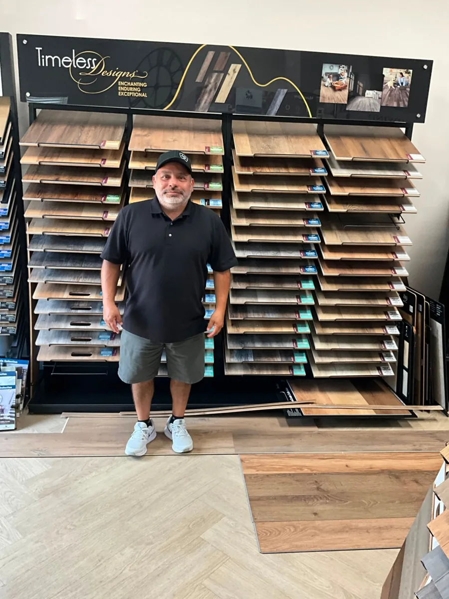 Carlos Garcia standing in front of the sample wall in his showroom